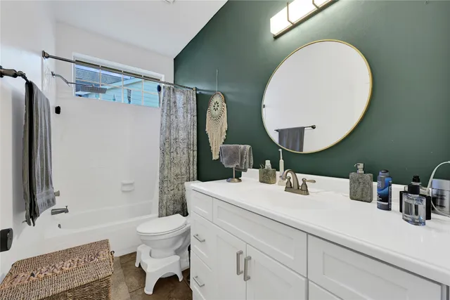 a bathroom with a sink mirror toilet and shower