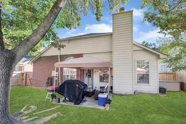 a front view of a house with a yard table and chairs