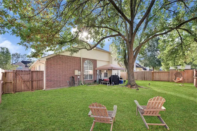 a view of a house with a yard and sitting area