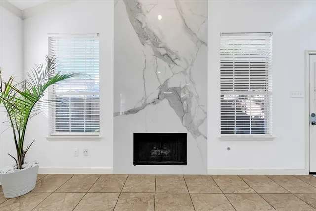 a view of a livingroom with a fireplace and window