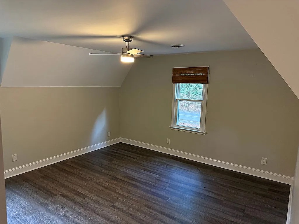 315 Rock Creek Road Clemson, SC 29631 - Photo 13 of 18 Angled ceilings and dark wood floors create a cozy, character-filled upper-level room.