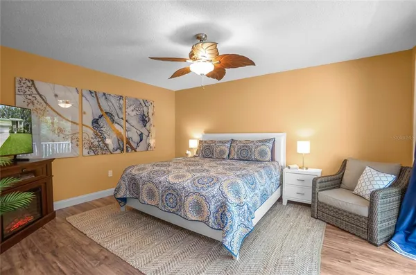 a bedroom with a bed couch and dresser