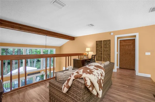 a bed sitting in a bedroom next to a balcony