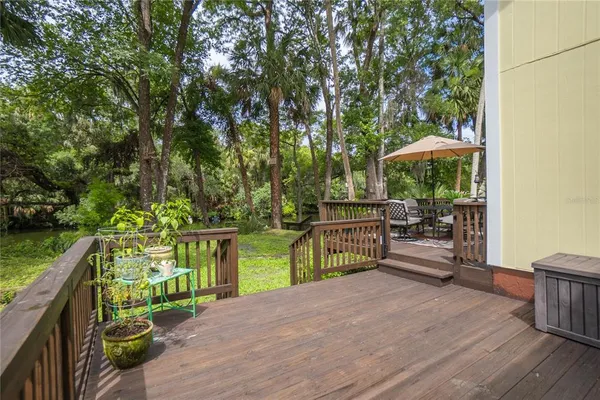 a view of a chair and table in the garden