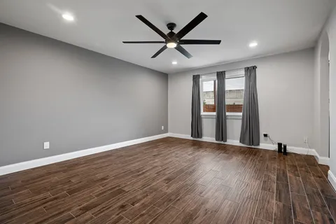 a kitchen with stainless steel appliances granite countertop a stove top oven a sink dishwasher a dining table and chairs with wooden floor