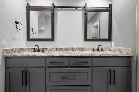a kitchen with stainless steel appliances granite countertop hardwood floor sink stove and granite counter top