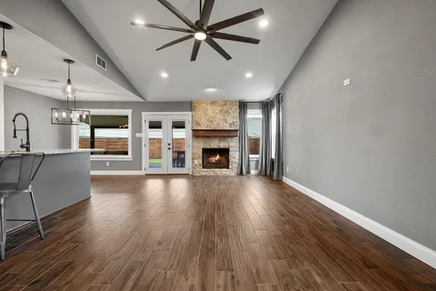 an open kitchen with furniture and a fireplace