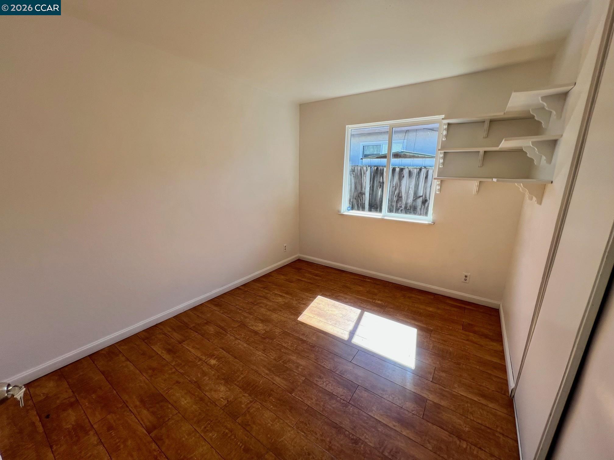 29 Sandview Drive Bay Point, CA 94565 - Photo 12 of 26 a view of an empty room with wooden floor and a window
