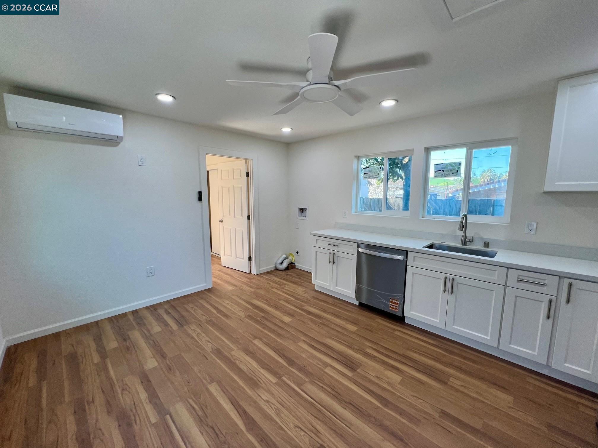 29 Sandview Drive Bay Point, CA 94565 - Photo 24 of 26 a large kitchen with stainless steel appliances granite countertop a dishwasher a stove and a sink with wooden floor