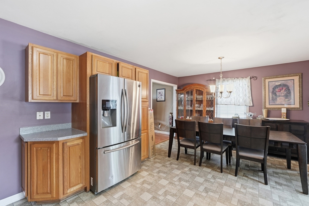 19 Annies Way Springfield, MA 01119 - Photo 10 of 40 a kitchen with stainless steel appliances granite countertop a refrigerator a stove a dining table and chairs with wooden floor