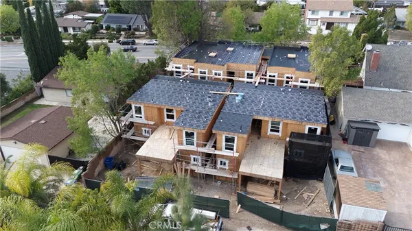 an aerial view of multiple houses with outdoor space
