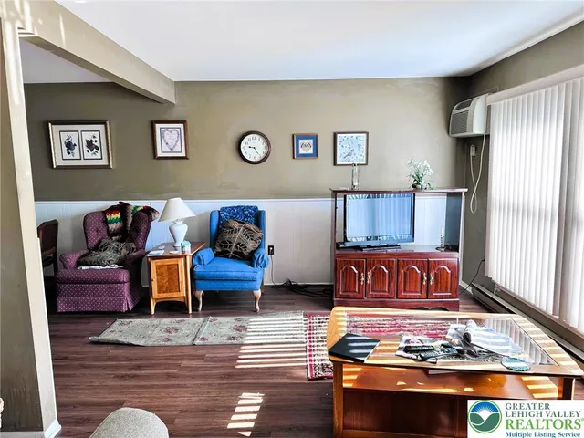 a living room with furniture rug and a window