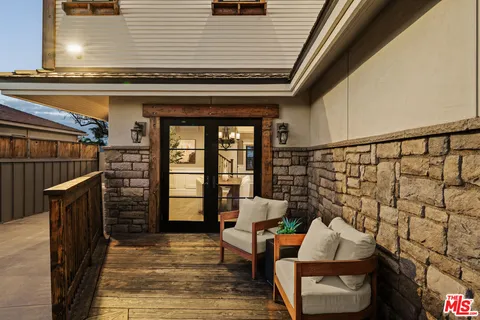 a view of an entryway with wooden floor and door