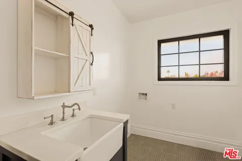 a bedroom with furniture and a large window