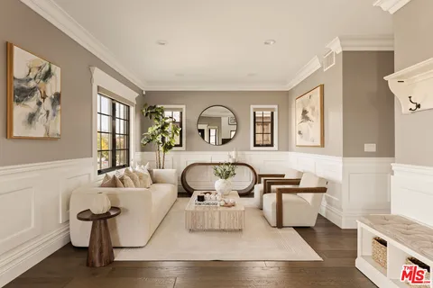 a view of a livingroom with furniture window and wooden floor