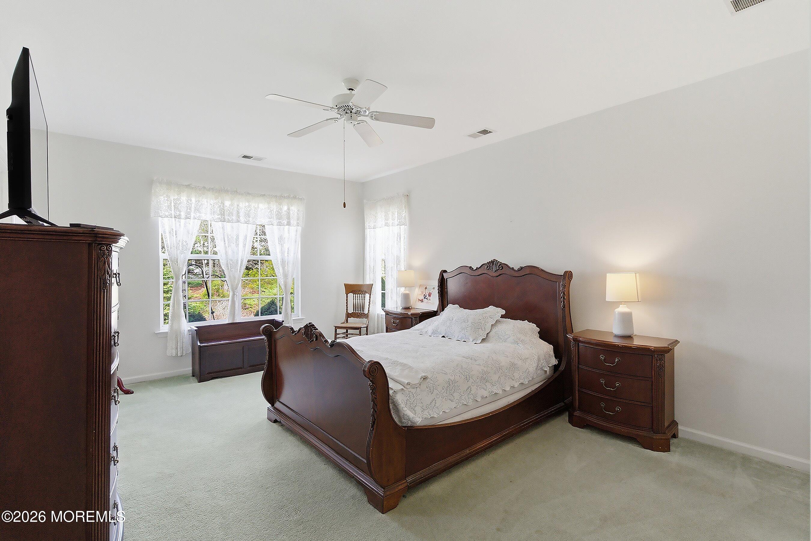 65 Mission Way Barnegat, NJ 08005 - Photo 18 of 51 a bedroom with a bed couch and a flat tv screen