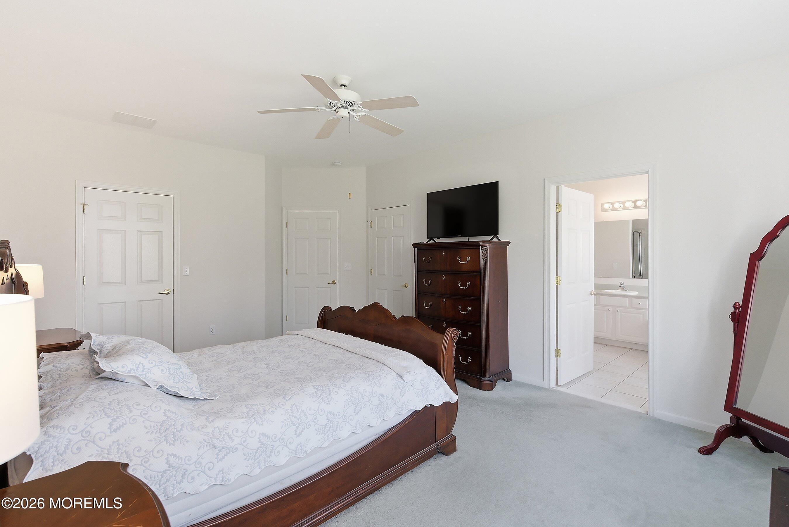 65 Mission Way Barnegat, NJ 08005 - Photo 19 of 51 a bedroom with a bed and a flat screen tv