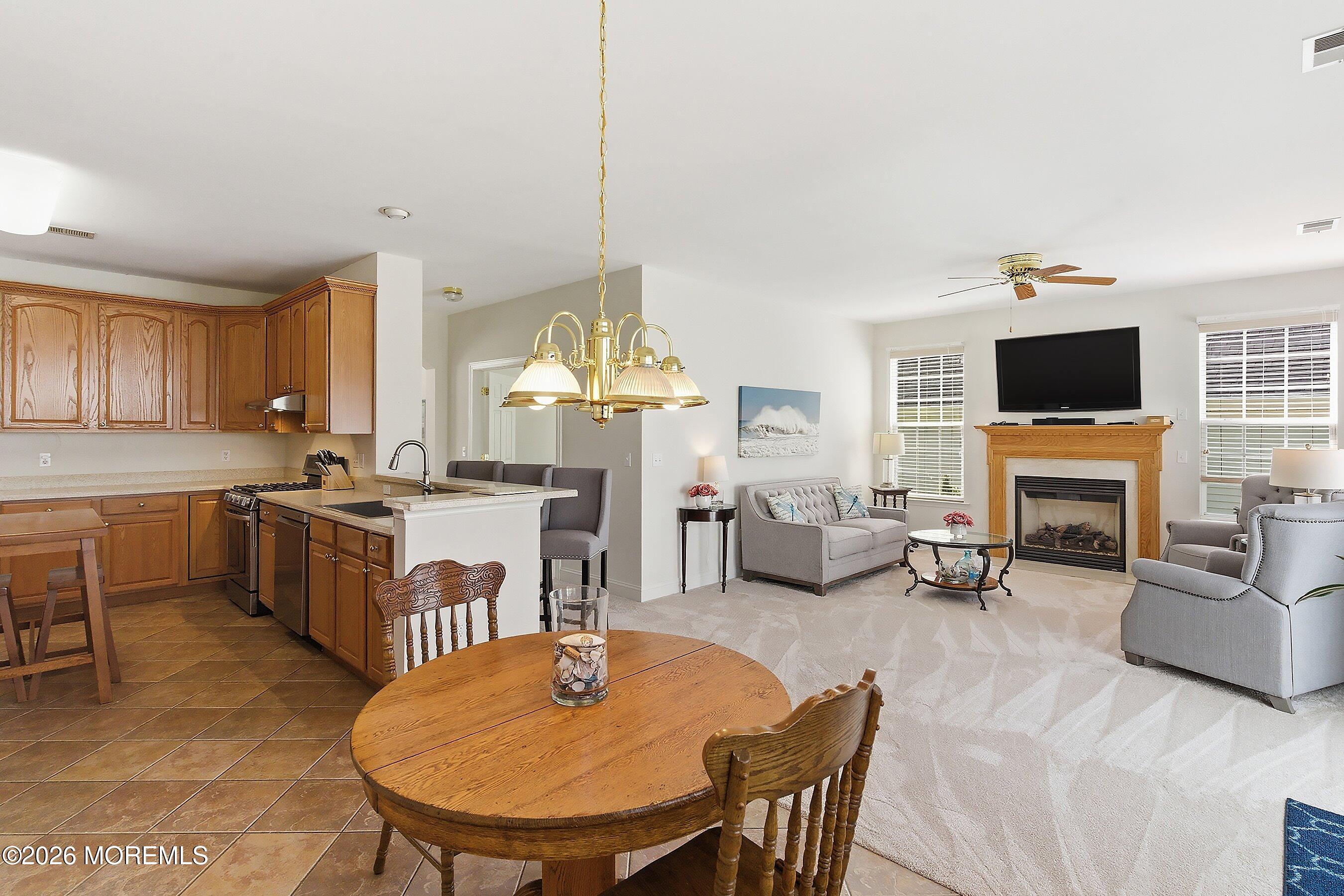 65 Mission Way Barnegat, NJ 08005 - Photo 5 of 51 a kitchen with sink refrigerator dining table and chairs