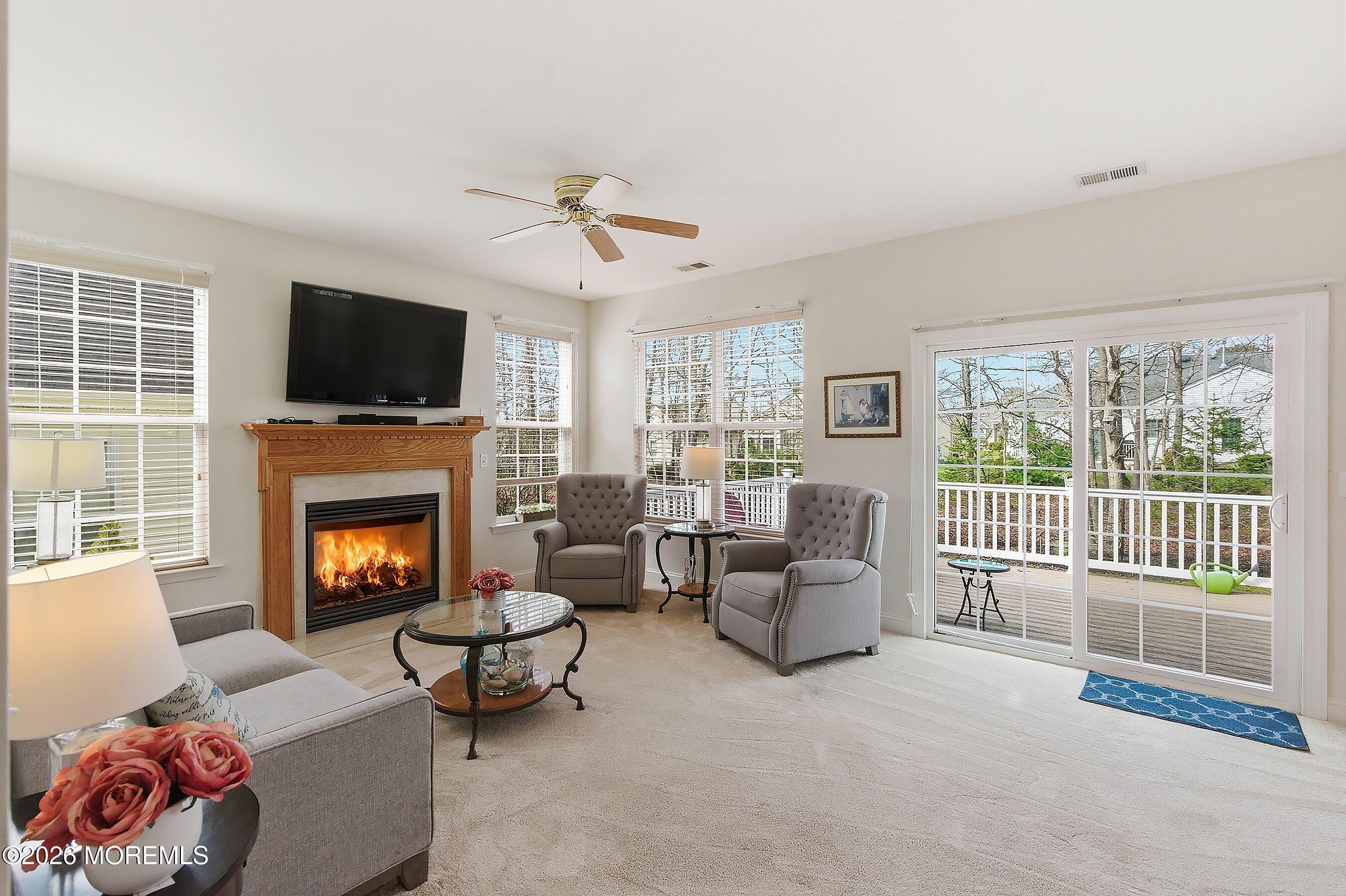 65 Mission Way Barnegat, NJ 08005 - Photo 8 of 51 a living room with furniture a flat screen tv and a fireplace