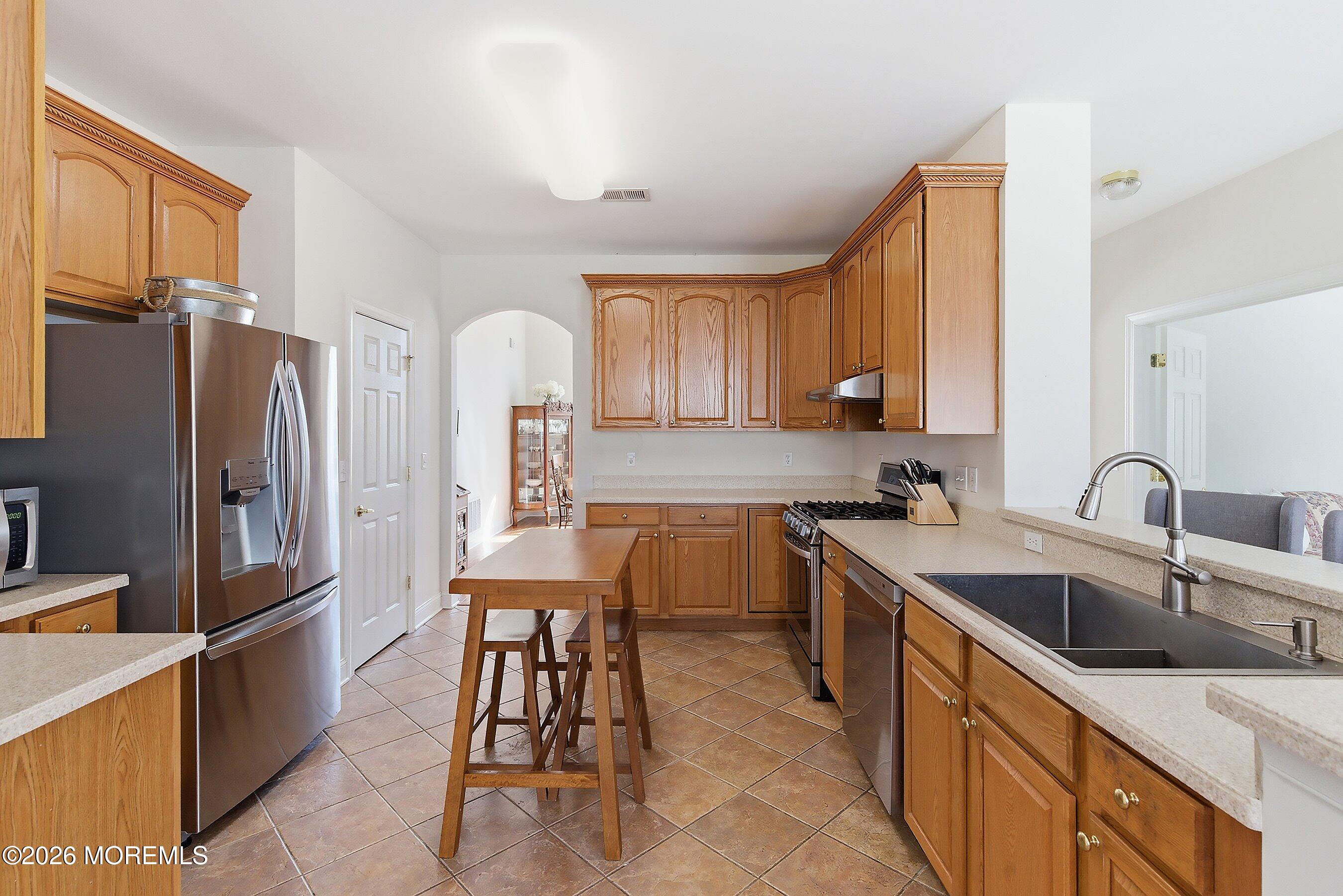 65 Mission Way Barnegat, NJ 08005 - Photo 10 of 51 a kitchen with stainless steel appliances granite countertop a sink refrigerator and cabinets