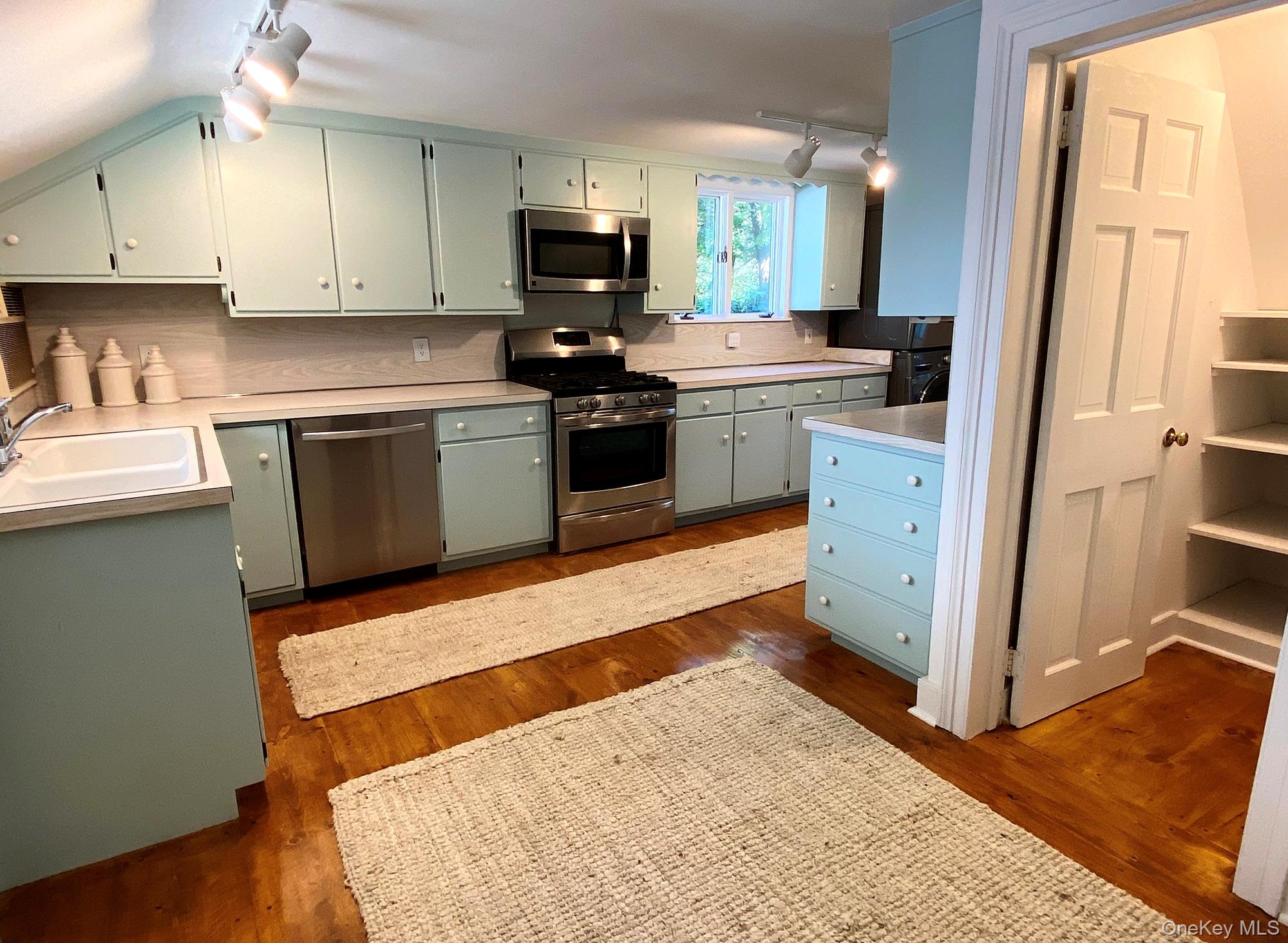 645 Tyrrel Road Millbrook, NY 12545 - Photo 12 of 39 a kitchen with stainless steel appliances kitchen island granite countertop a sink stove and cabinets
