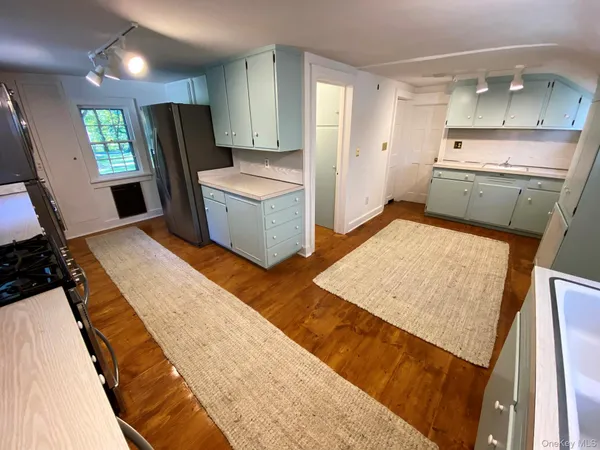 a kitchen with a sink stove and refrigerator