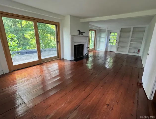 wooden floor in an empty room with a fireplace