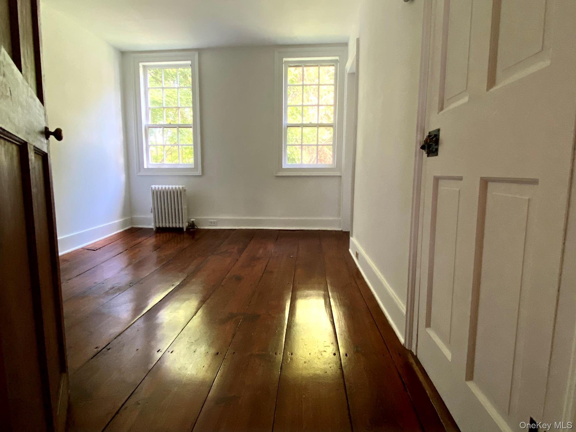 645 Tyrrel Road Millbrook, NY 12545 - Photo 22 of 39 a view of an empty room with wooden floor and a window