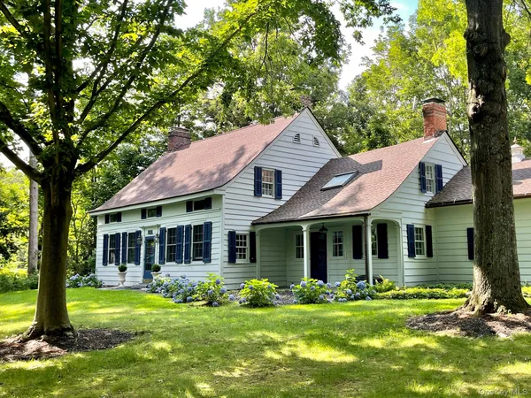 a front view of a house with a garden and porch