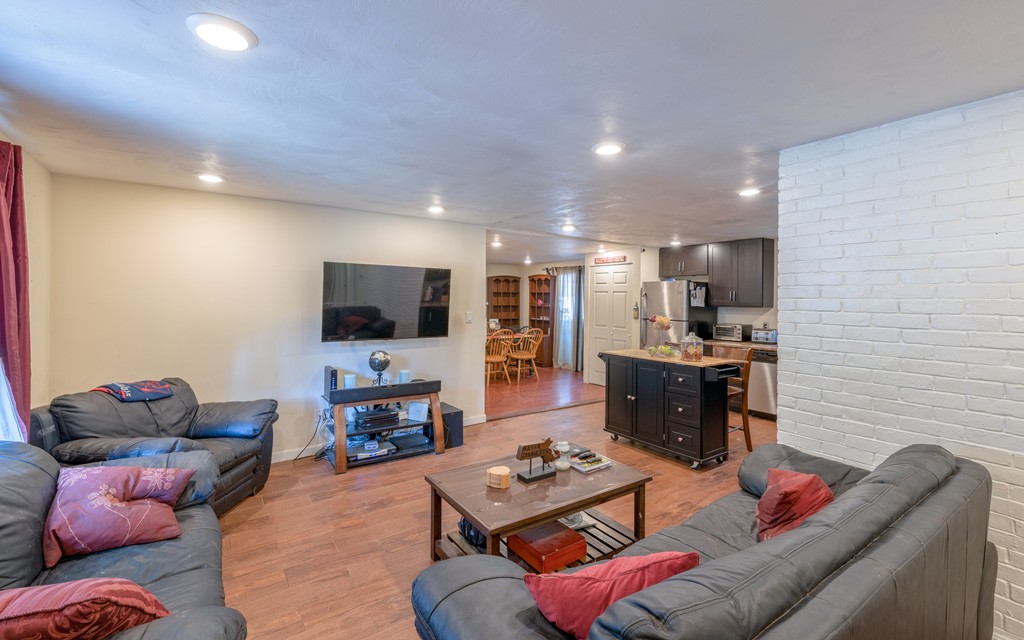 40 Christopher Road Brockton, MA 02302 - Photo 11 of 27 a living room with furniture and a flat screen tv