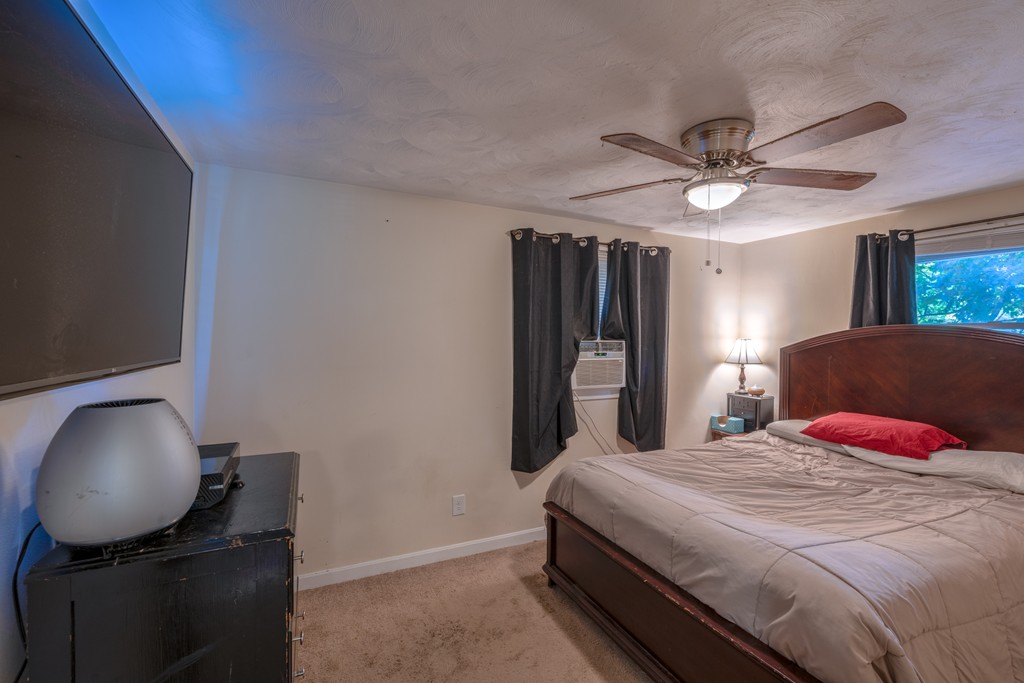 40 Christopher Road Brockton, MA 02302 - Photo 17 of 27 a bedroom with a bed and a chandelier