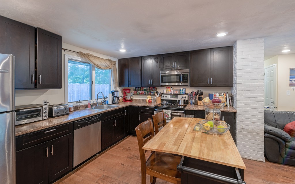 40 Christopher Road Brockton, MA 02302 - Photo 7 of 27 a kitchen with kitchen island granite countertop a sink counter top space appliances and cabinets