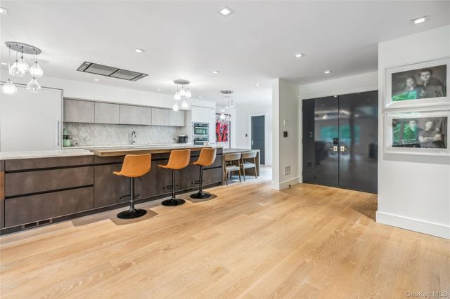 a large white kitchen with a large window