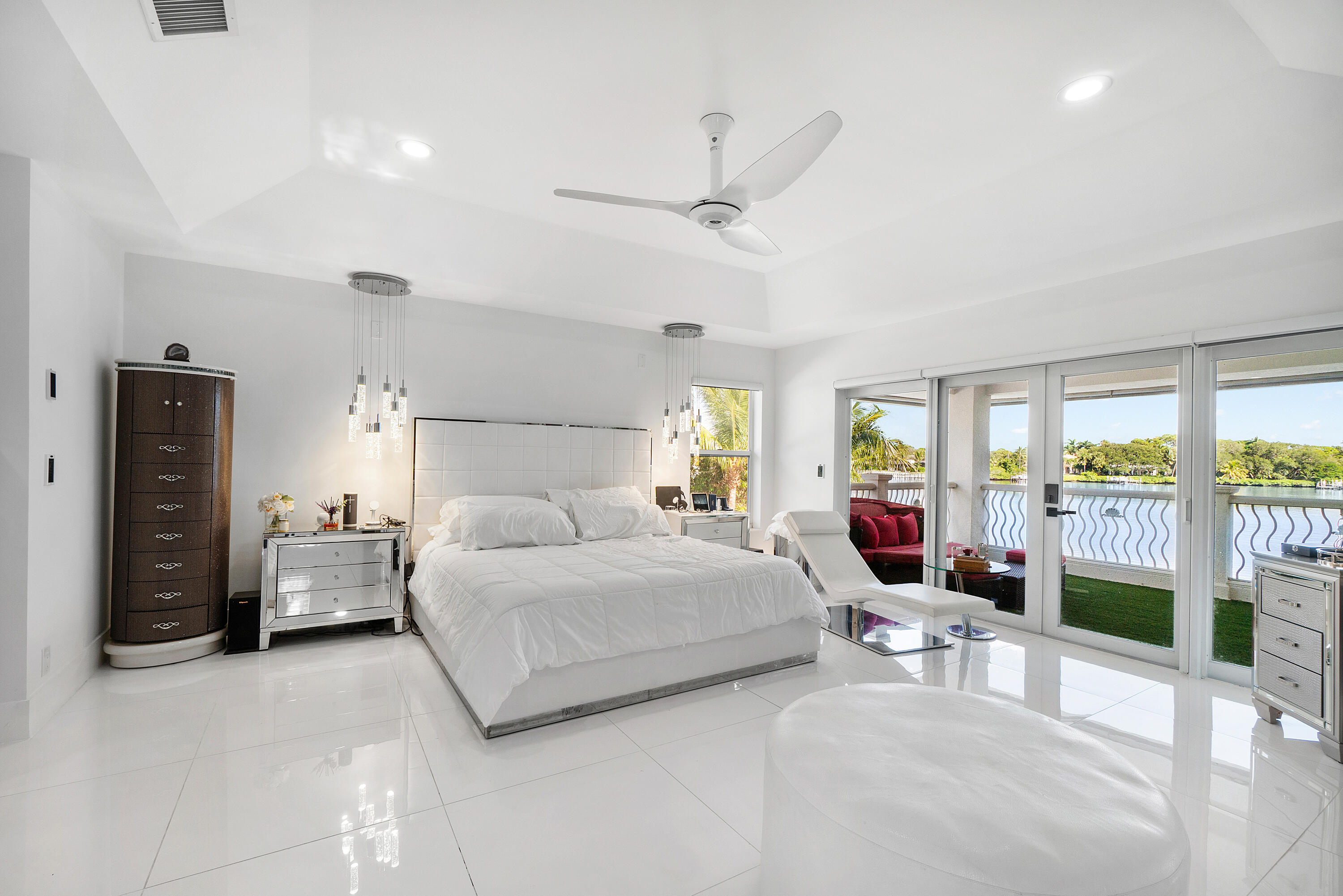 5447 Center Street Jupiter, FL 33458 - Photo 32 of 60 a bedroom with a bed and ceiling fan