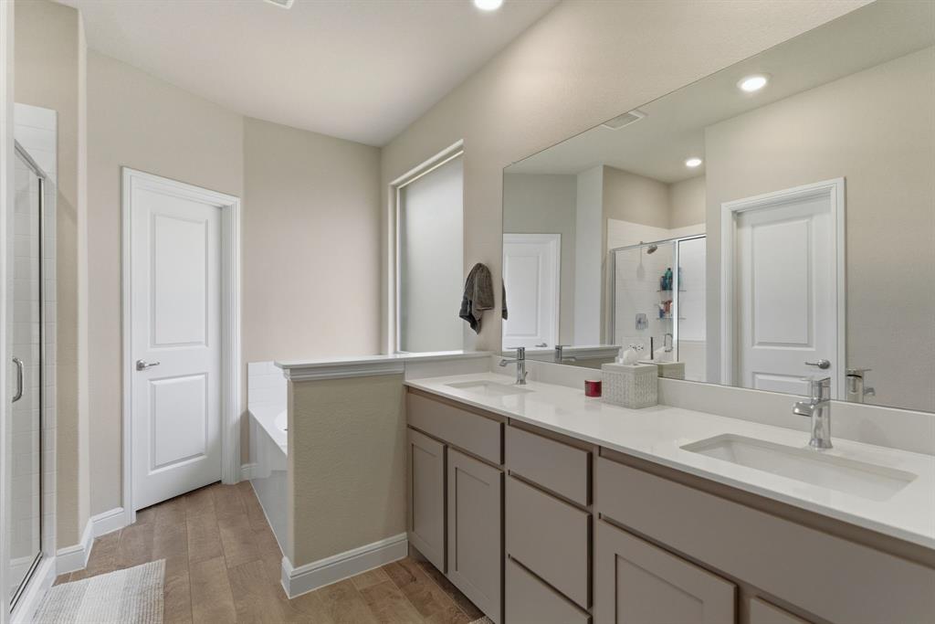 5621 Round Hl Road Denton, TX 76210 - Photo 18 of 27 a bathroom with double sink and a mirror