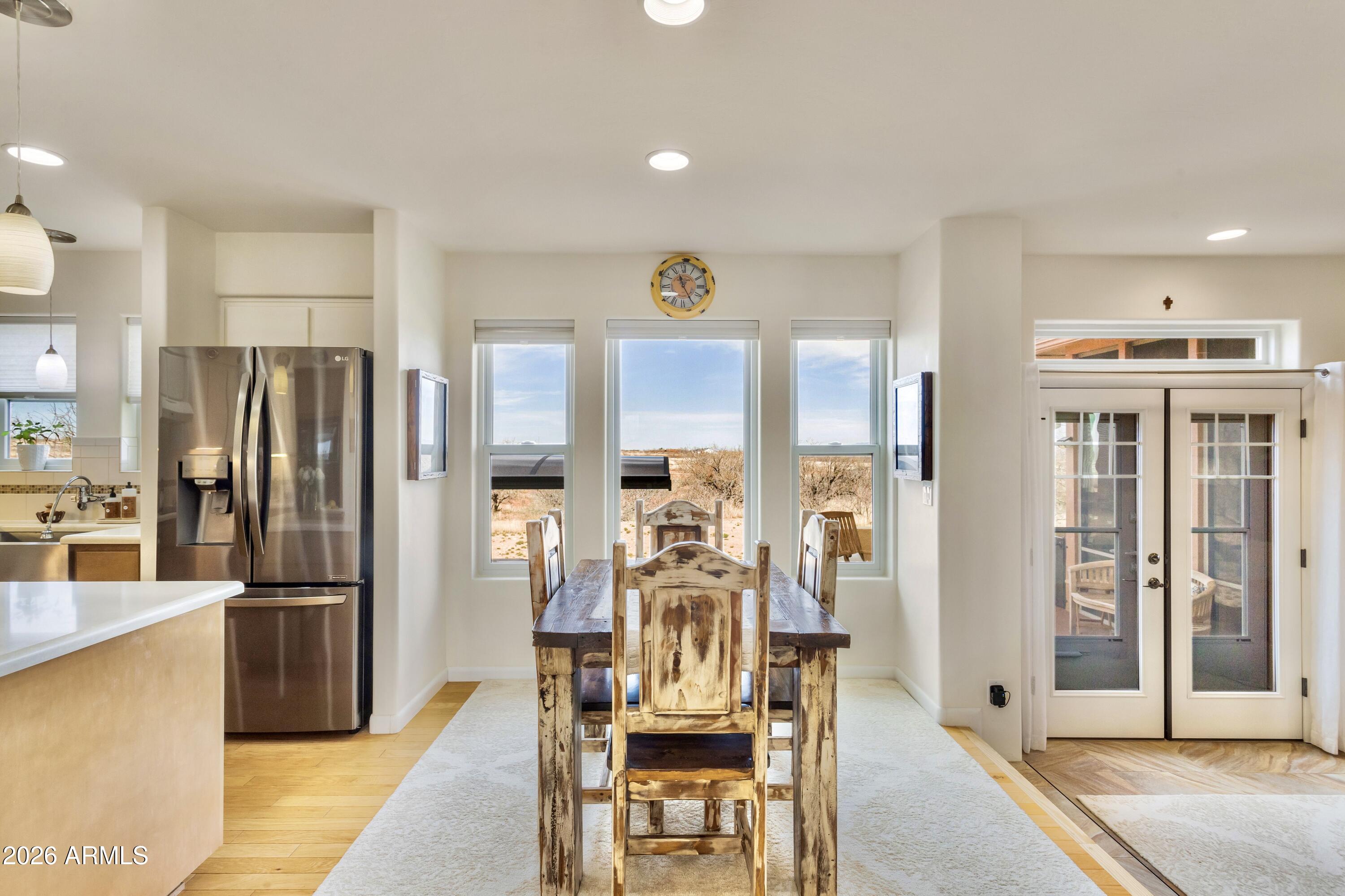 8541 South Almosta Ranch Road Hereford, AZ 85615 - Photo 11 of 53 a view of a kitchen with dining area refrigerator and wooden floor