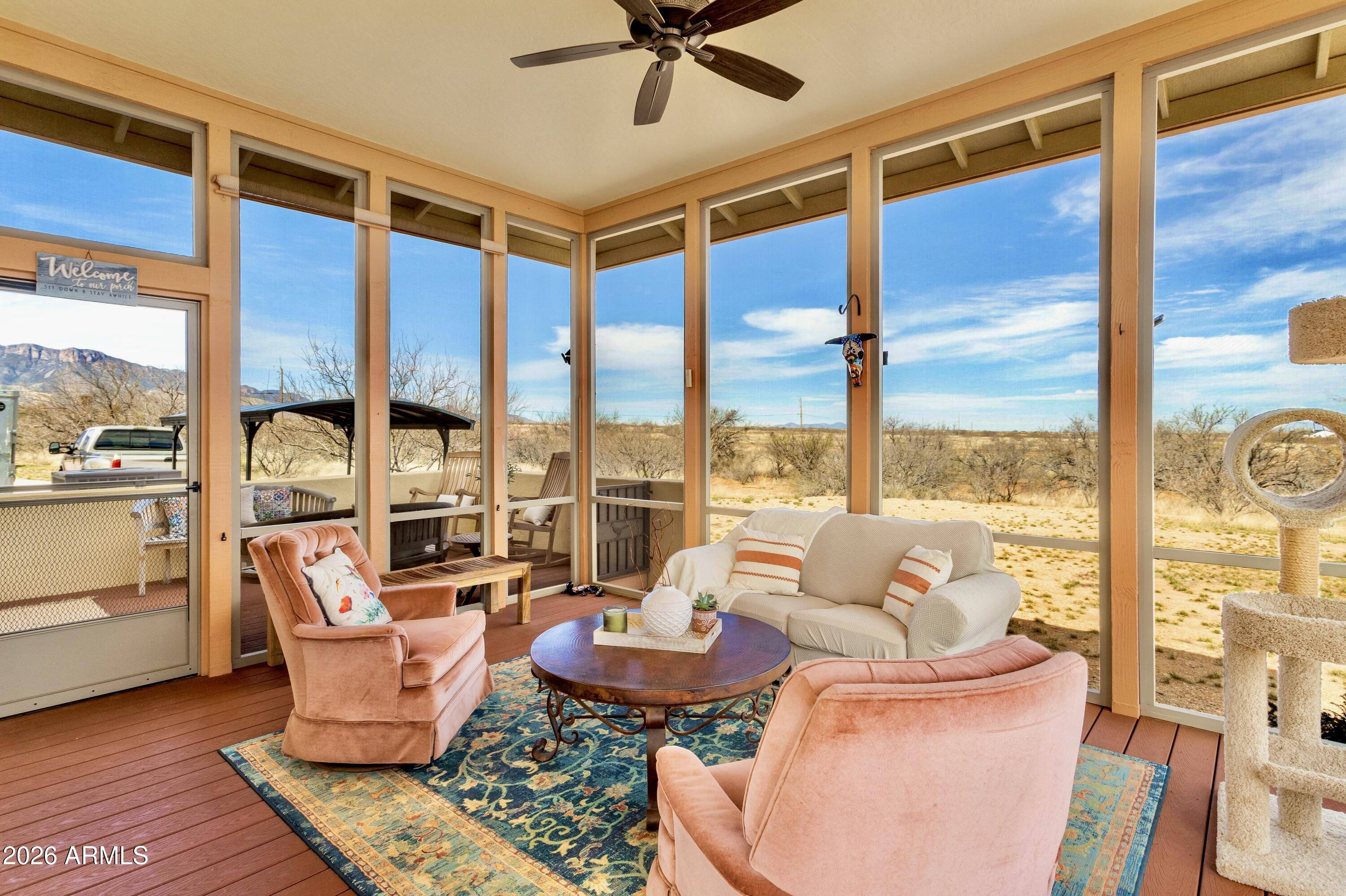 8541 South Almosta Ranch Road Hereford, AZ 85615 - Photo 13 of 53 a living room with furniture and a floor to ceiling window