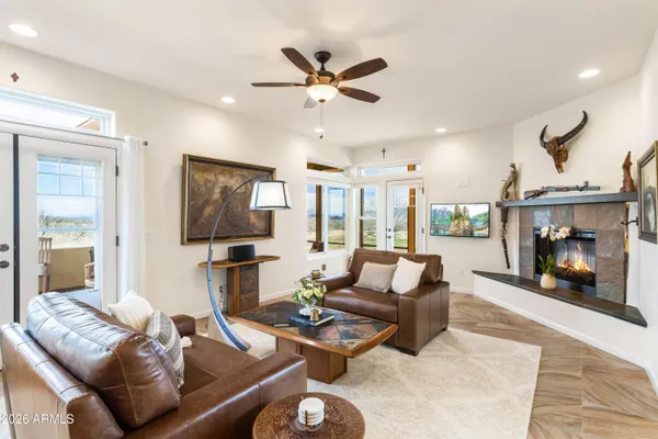 a living room with furniture and a view of kitchen