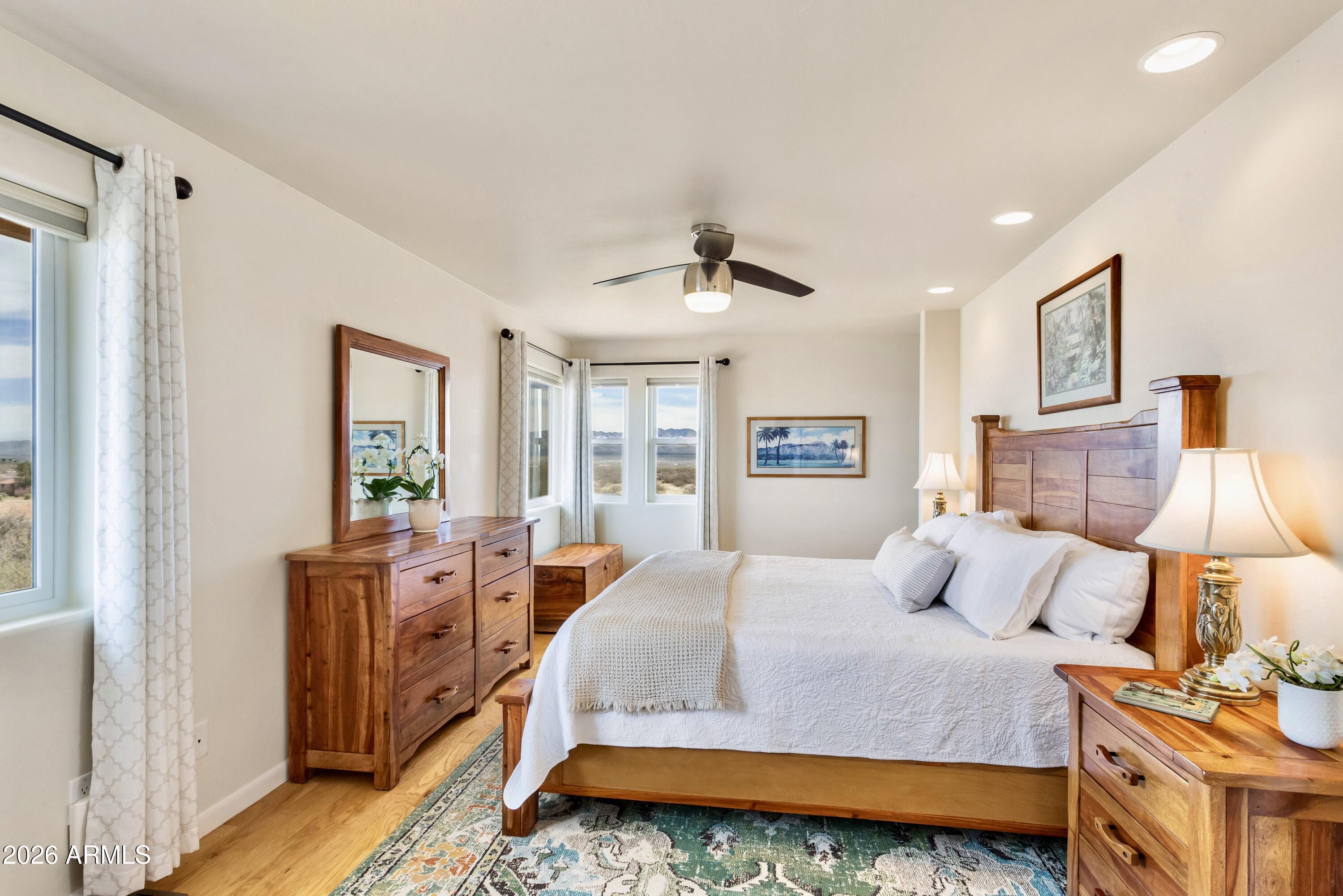8541 South Almosta Ranch Road Hereford, AZ 85615 - Photo 23 of 53 a bedroom with a bed and wooden floor