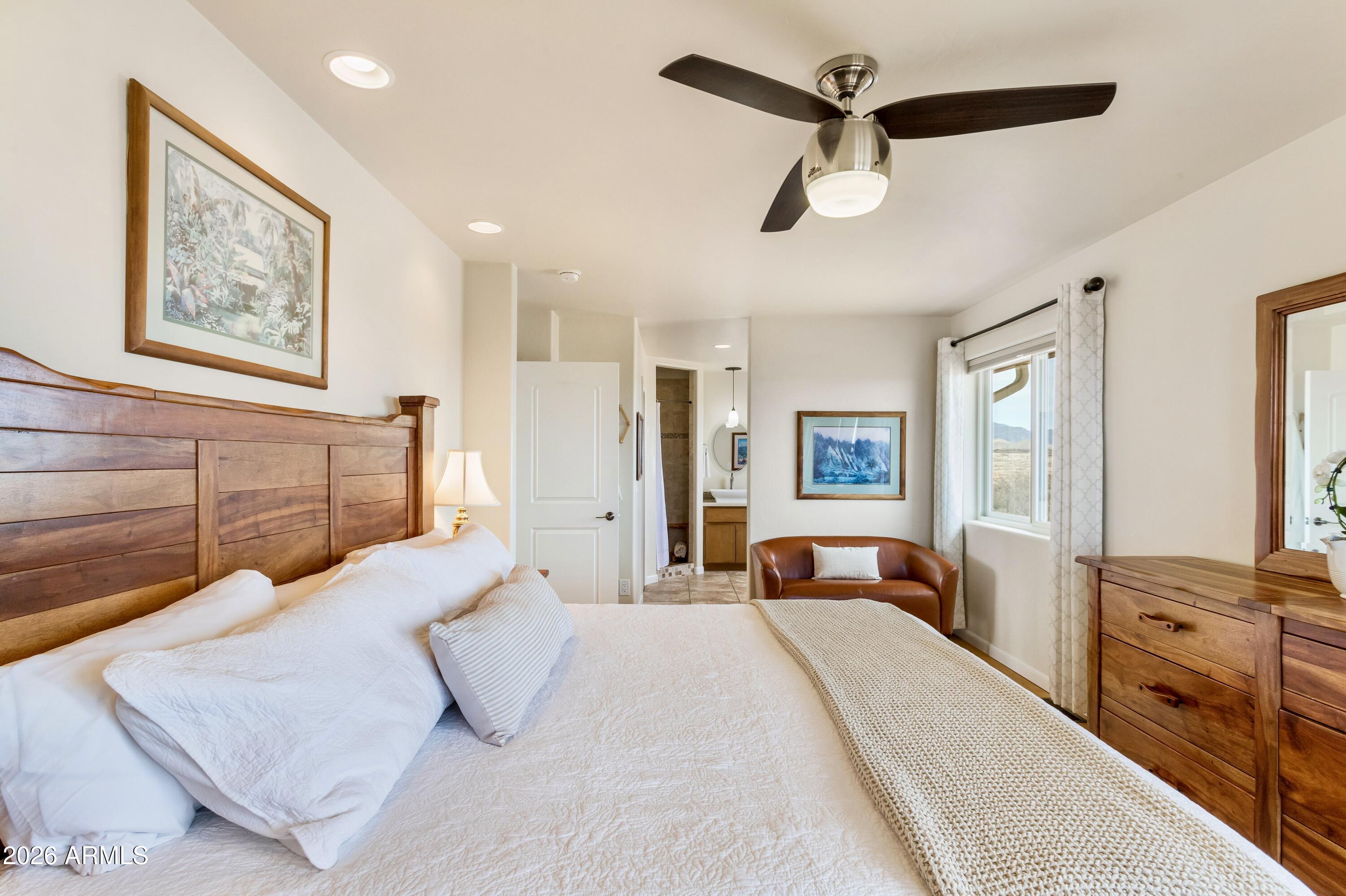 8541 South Almosta Ranch Road Hereford, AZ 85615 - Photo 25 of 53 a bedroom with a large bed and a chandelier