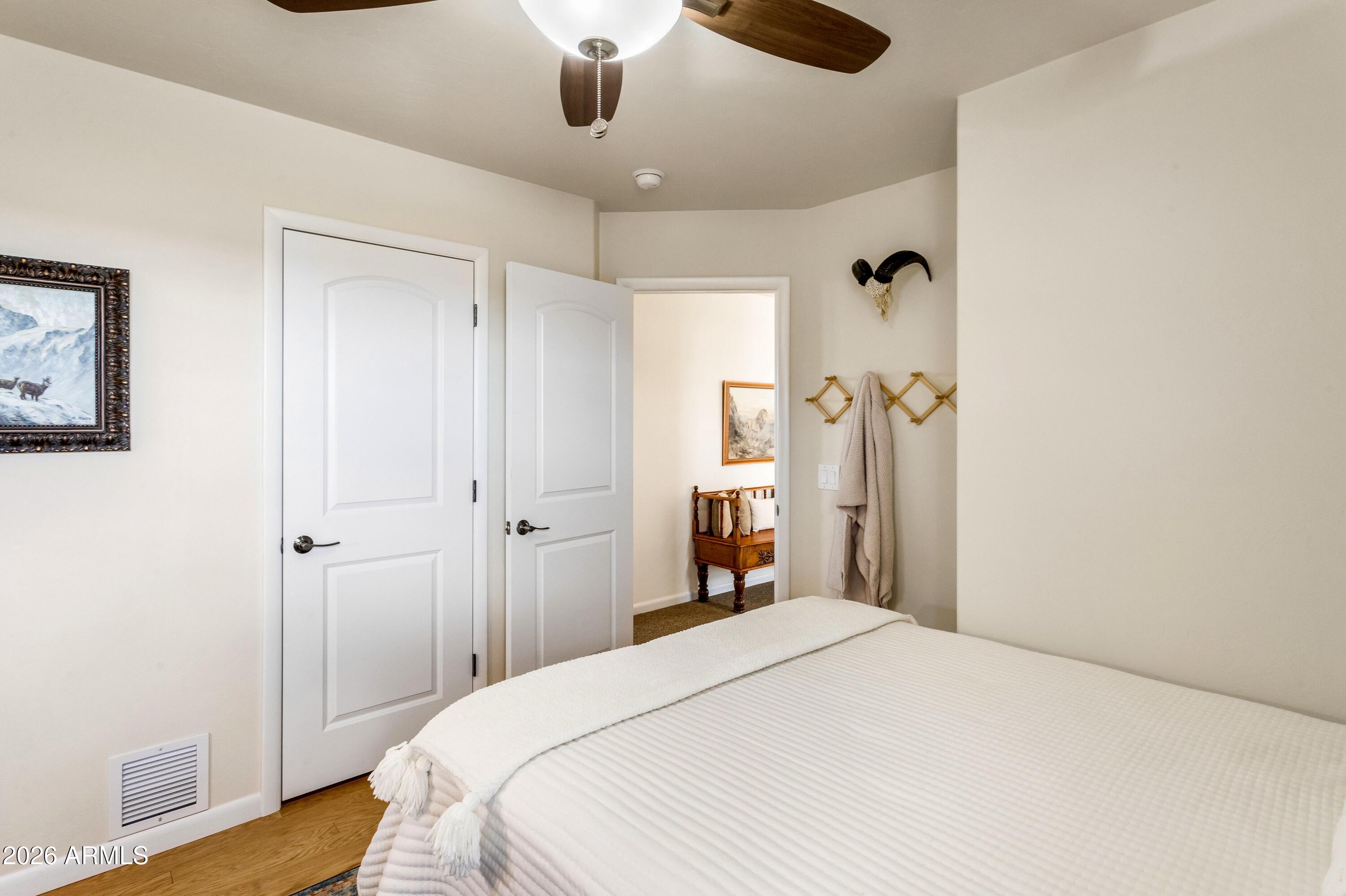 8541 South Almosta Ranch Road Hereford, AZ 85615 - Photo 34 of 53 a bedroom with a bed and a wooden floor