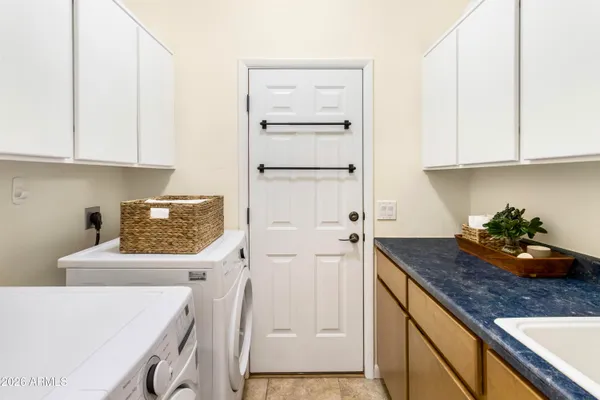 a bathroom with a granite countertop sink and mirror