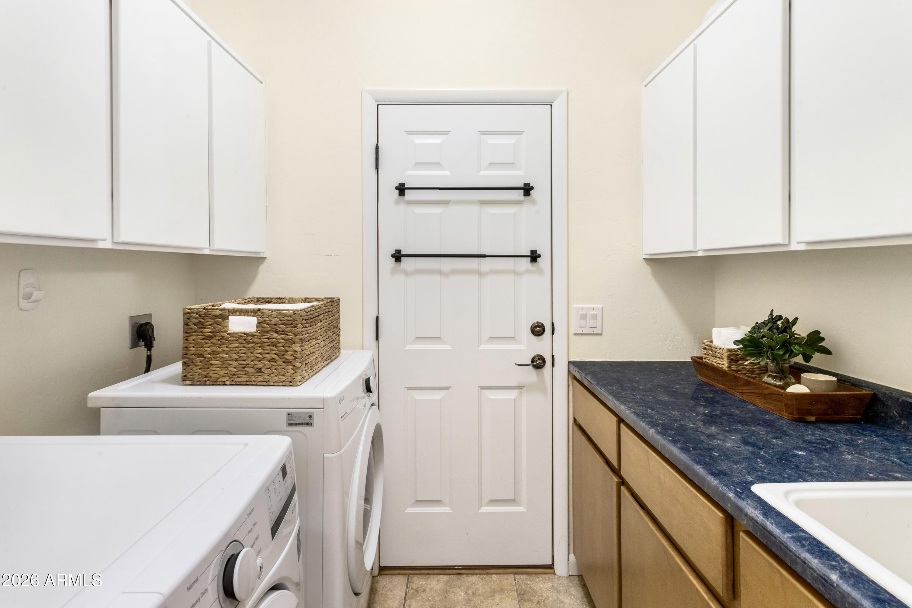 8541 South Almosta Ranch Road Hereford, AZ 85615 - Photo 40 of 53 a kitchen with a refrigerator and cabinets