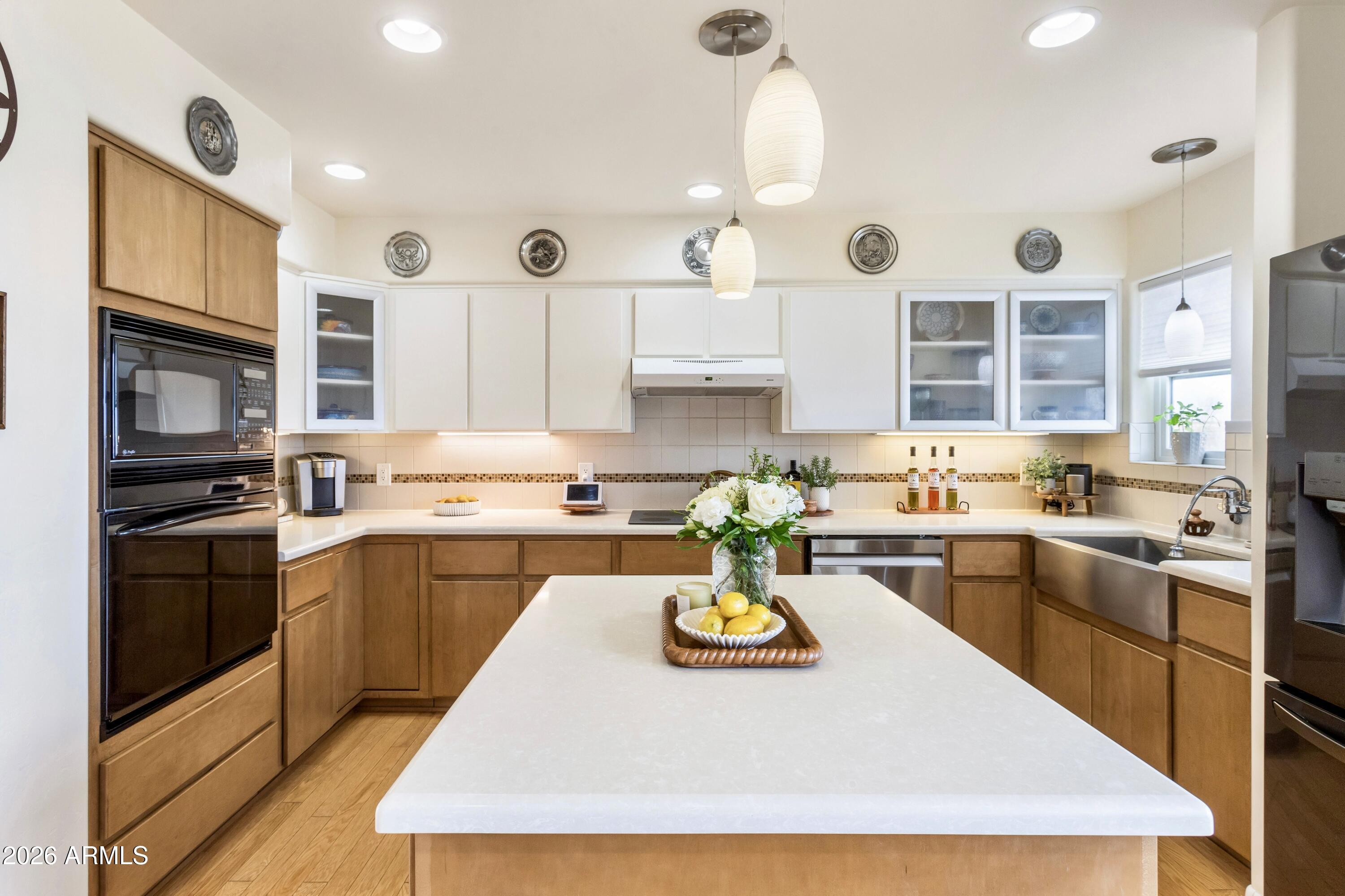 8541 South Almosta Ranch Road Hereford, AZ 85615 - Photo 8 of 53 a kitchen with a stove a refrigerator and a dining table with wooden floor