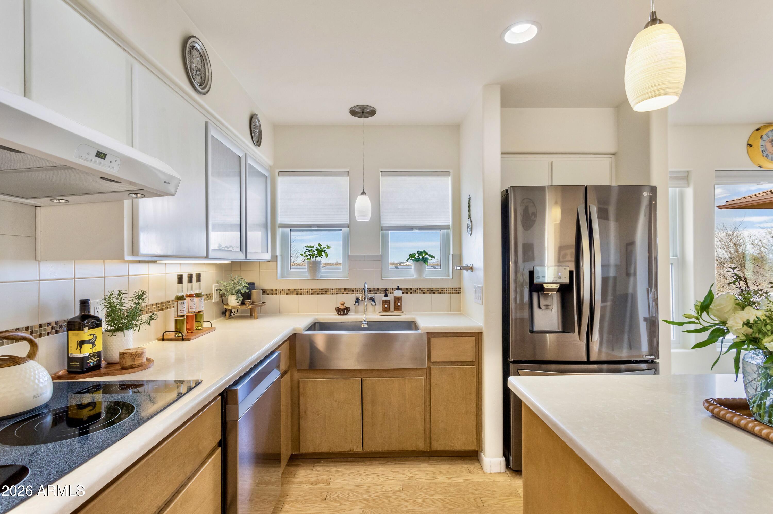 8541 South Almosta Ranch Road Hereford, AZ 85615 - Photo 10 of 53 a kitchen with stainless steel appliances granite countertop a sink a stove and a refrigerator