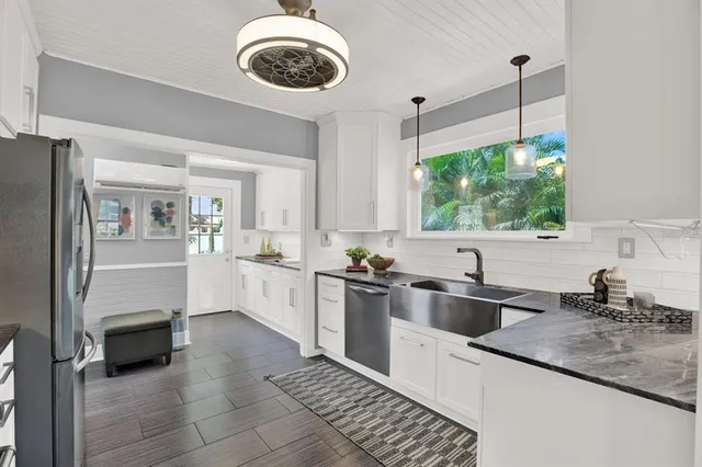 a kitchen with a sink cabinets and window