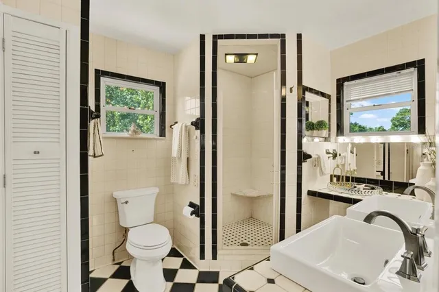 a bathroom with a sink toilet and shower