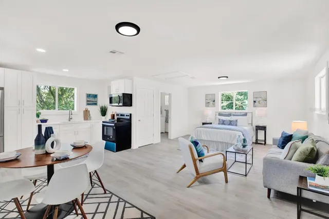 a living room with furniture and wooden floor