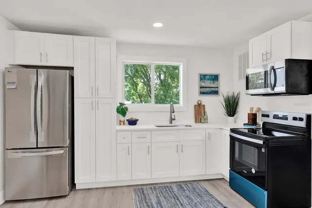 a kitchen with a refrigerator sink and stove