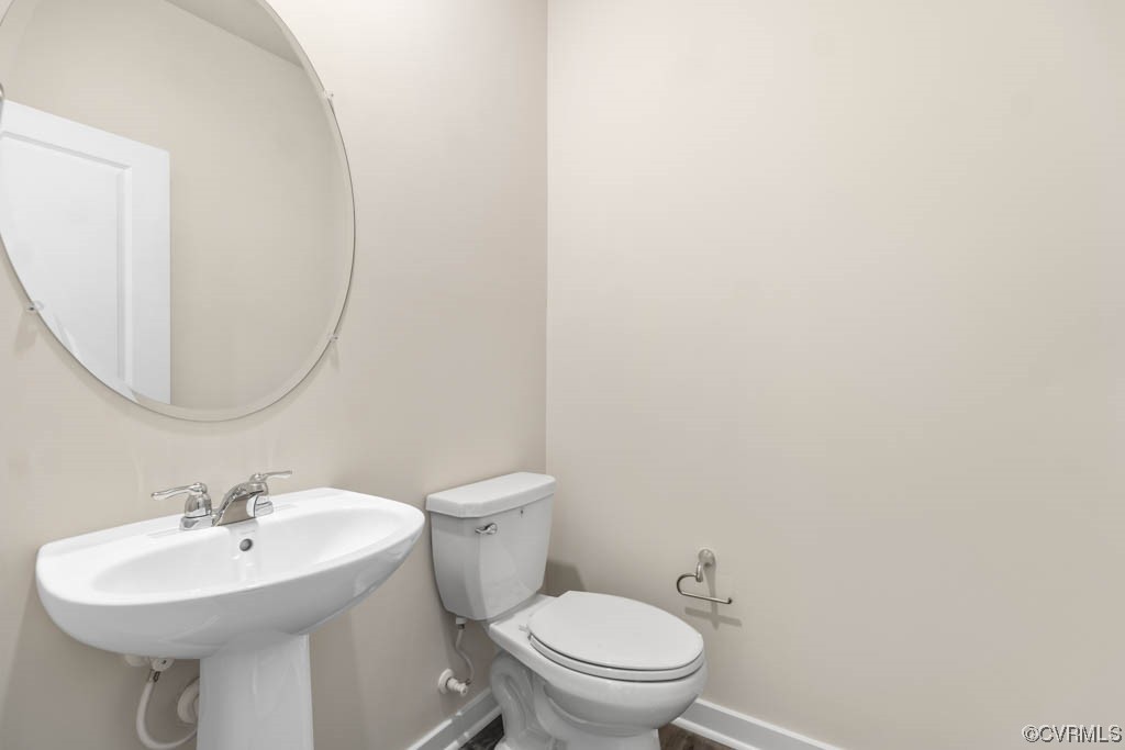 9206 Moldova Road Chesterfield, VA 23832 - Photo 9 of 40 a bathroom with a sink a toilet and a mirror